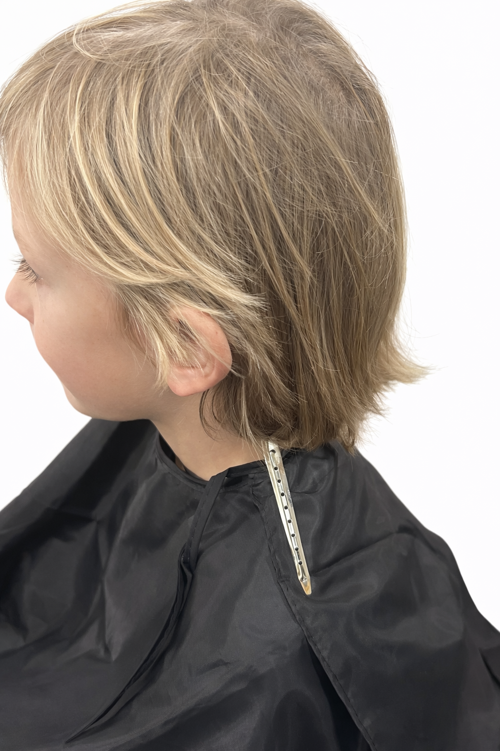 Child's layered bob haircut with natural highlights