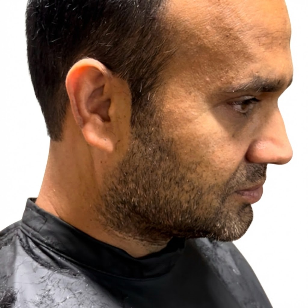 Men's short fade haircut with clean lines and beard trim